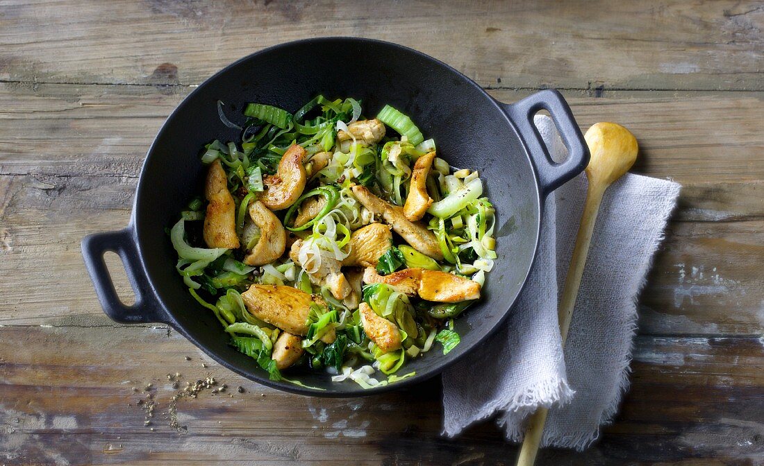 Green Chinese stir-fry with chicken breast, bok choy and leek
