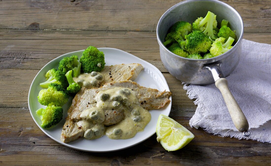 Veal escalope with a caper and cream cheese sauce and broccoli
