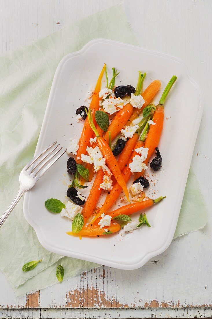 A baby carrot salad with feta cheese, olives and mint