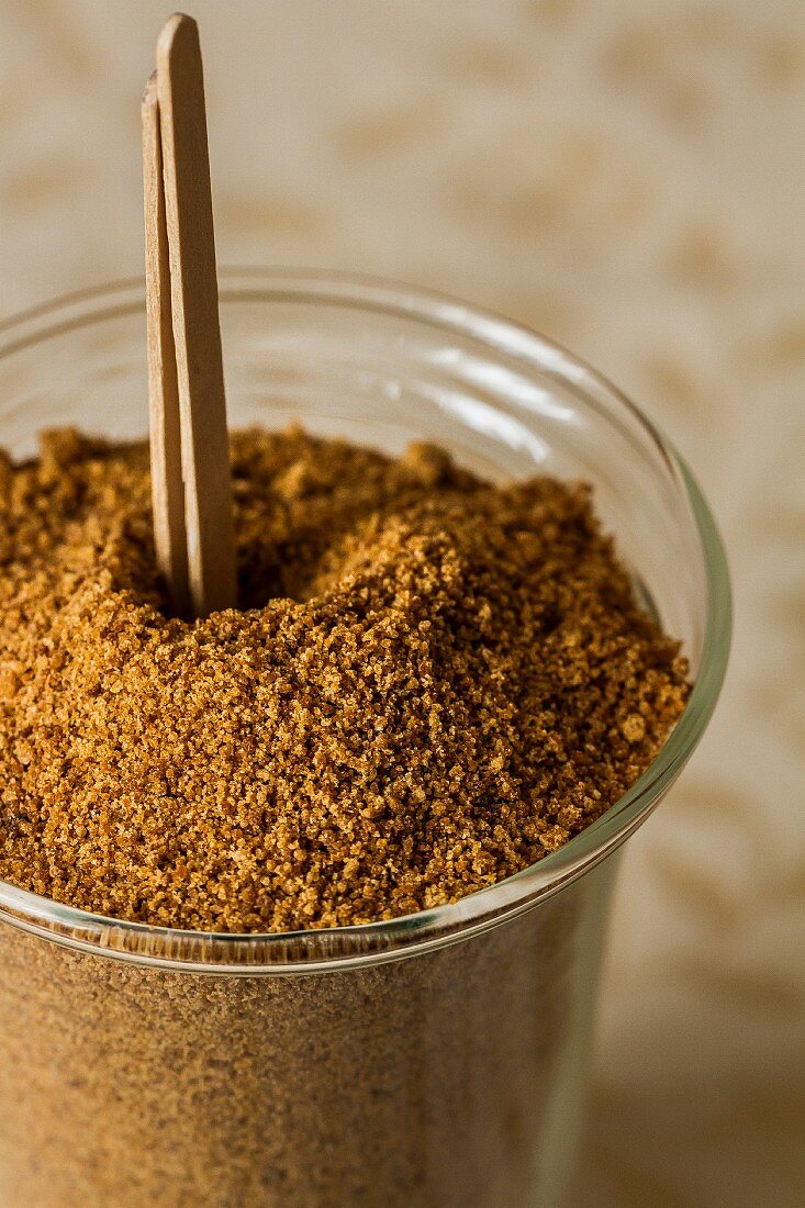 Coconut flower sugar in a glass with wooden sticks