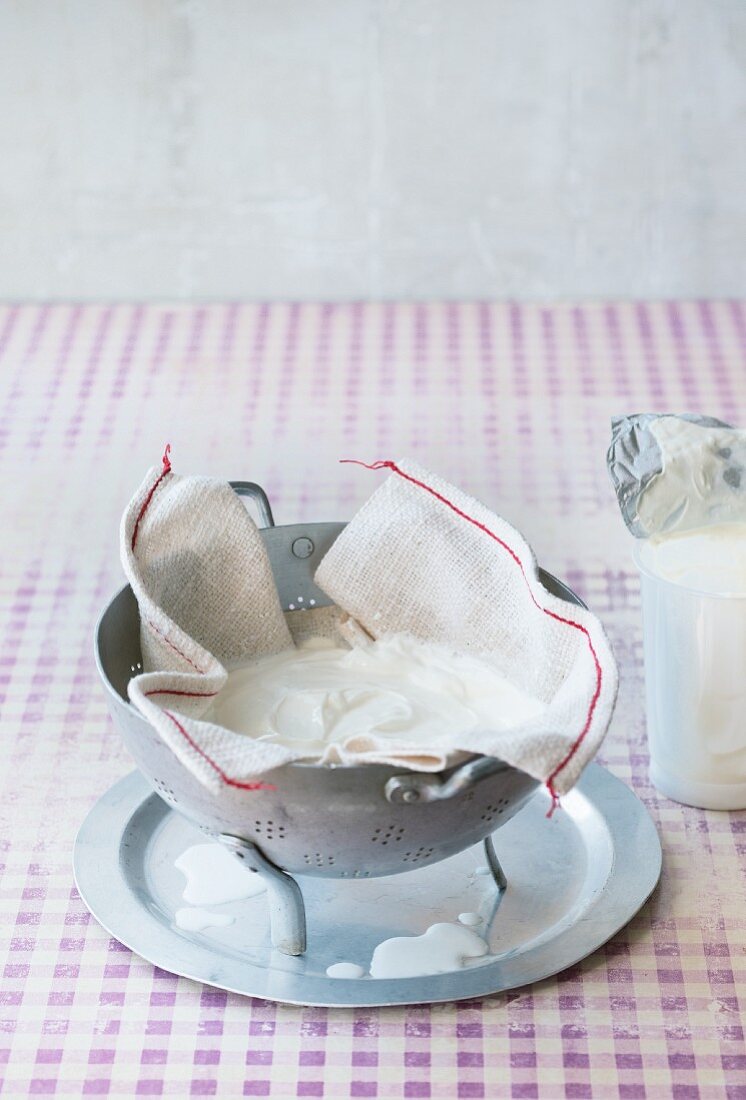 Yoghurt being drained in a muslin cloth