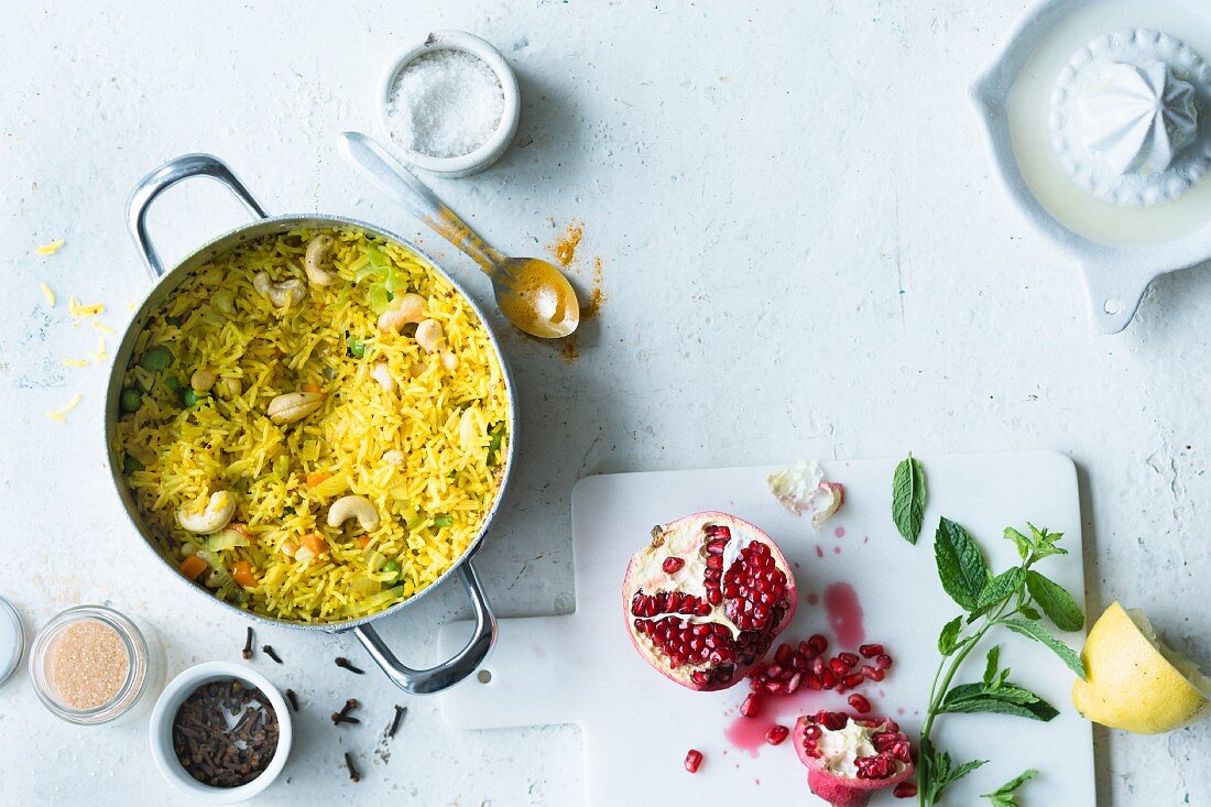 Oriental rice with turmeric and cashew nuts served with pomegranate seeds