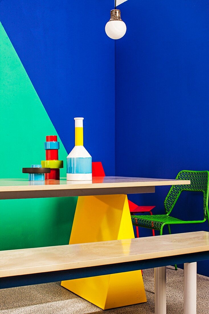 Painted wall, furniture and arrangement of vases in bold combination of colours