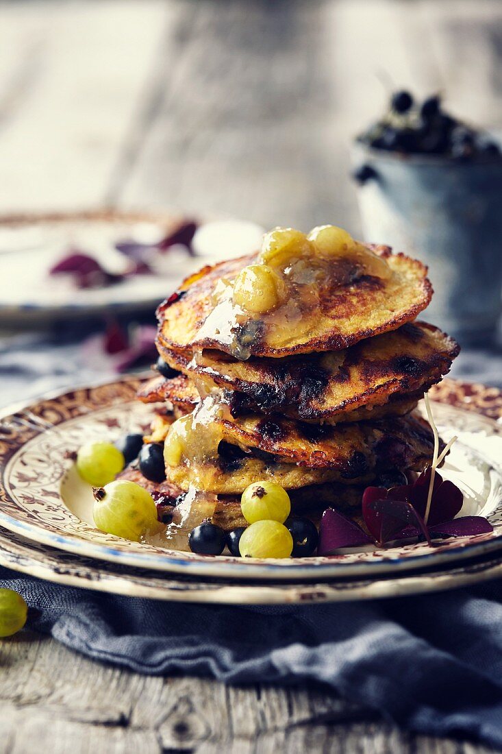 Coconut pancakes with gooseberry jam and blackcurrants