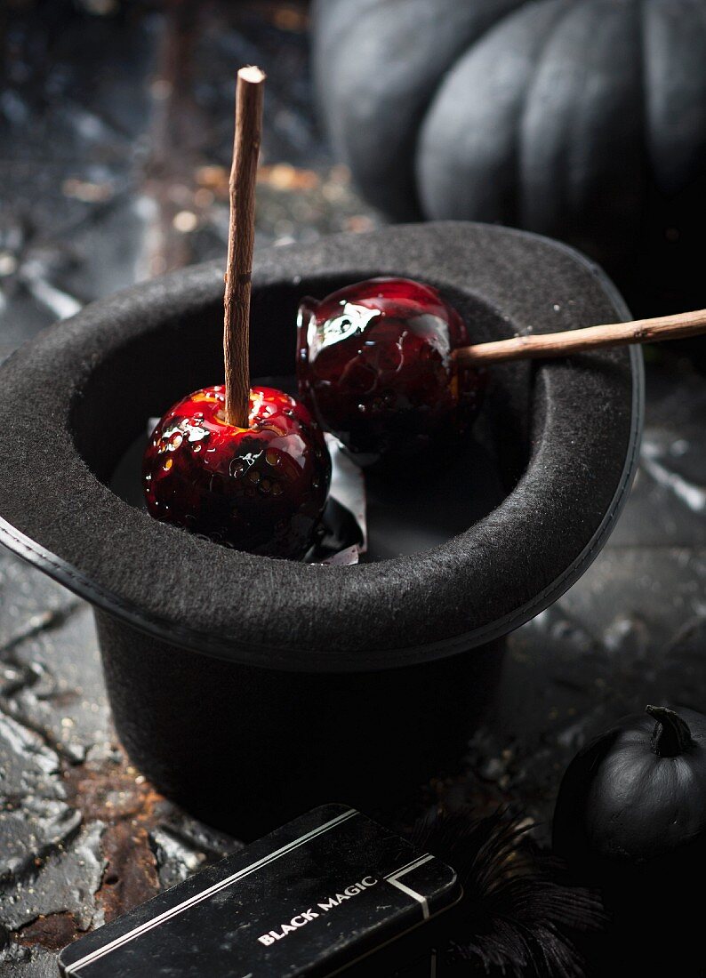 Toffee apples in a black hat
