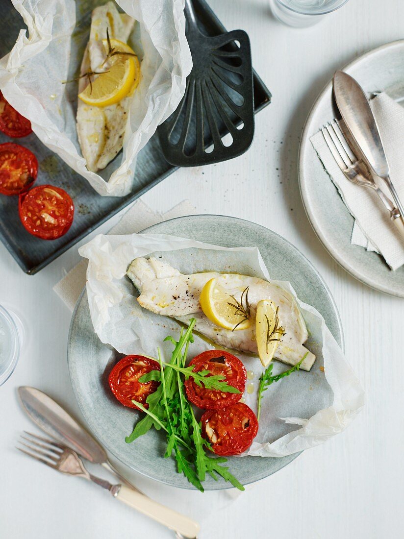 Seabass baked in parchment with roasted tomatoes with rocket