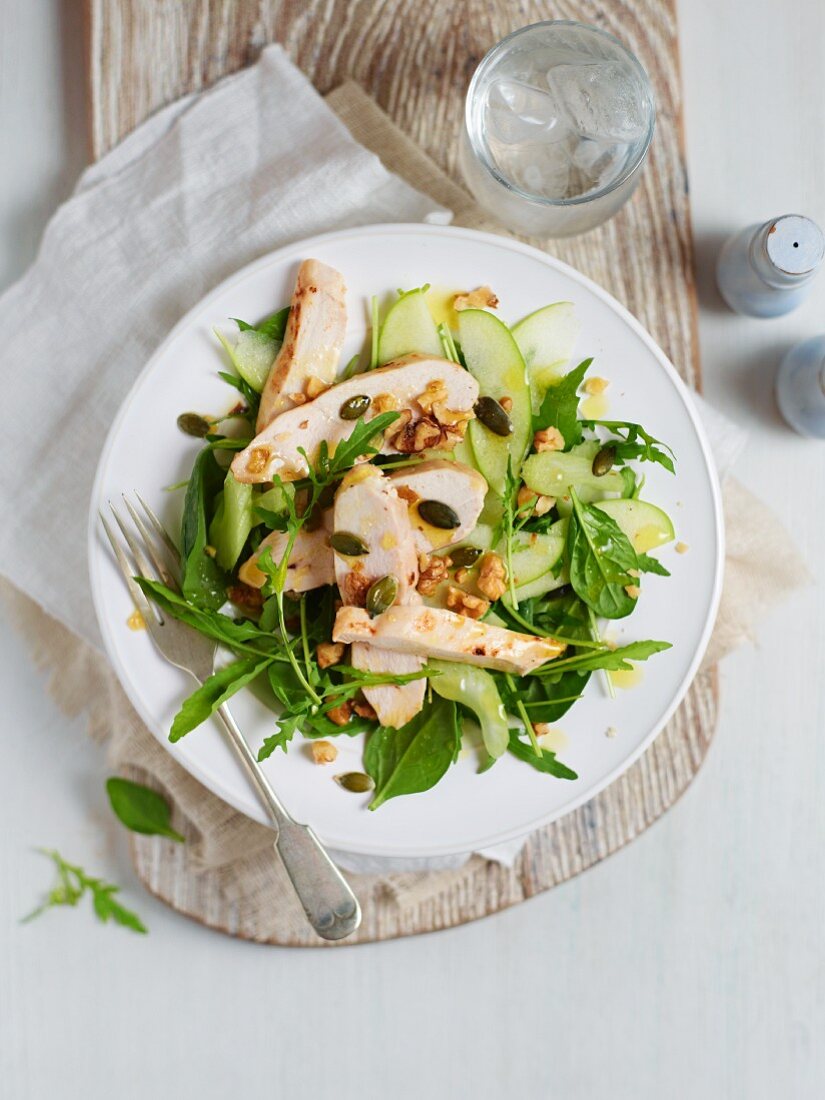 Green herb salad with chicken, apple and a nut dressing
