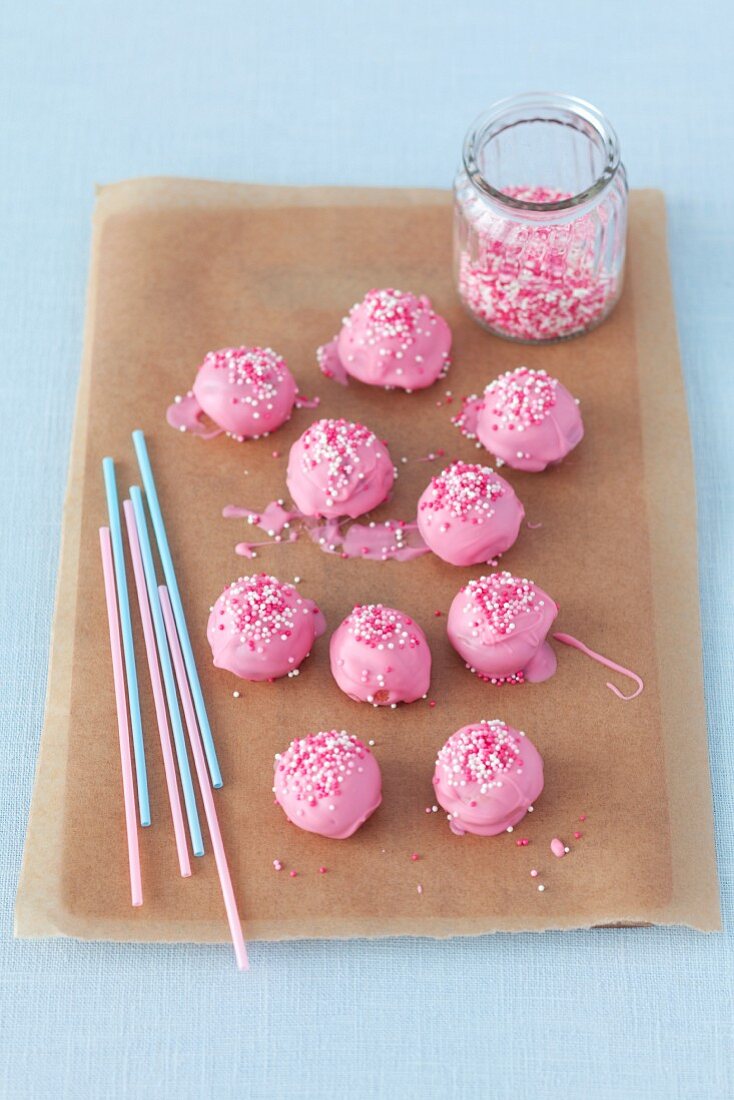 Pink cake pops on a piece of baking paper