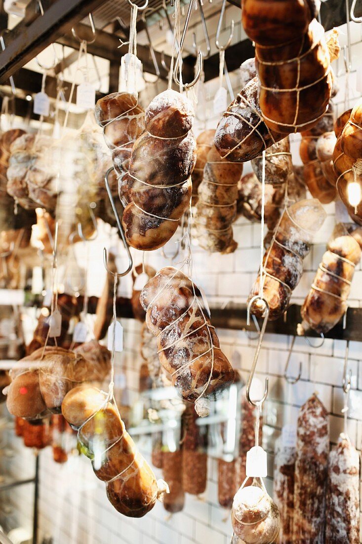 Ham and salami hanging in the 'Nomad' restaurant from the ceiling