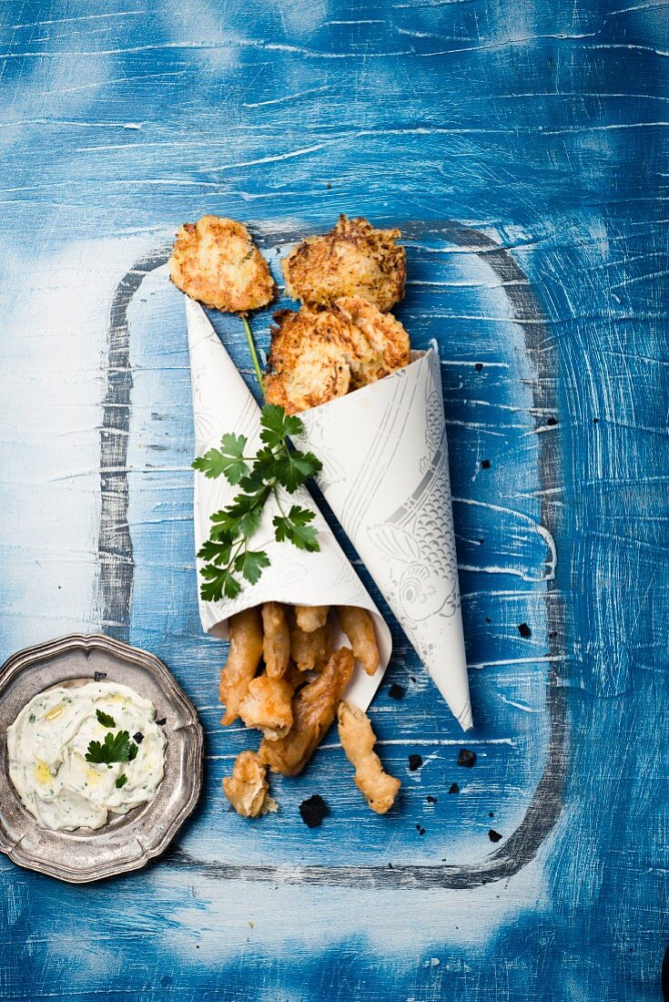 Fish tempura with potato and onion fritters and a herb dip