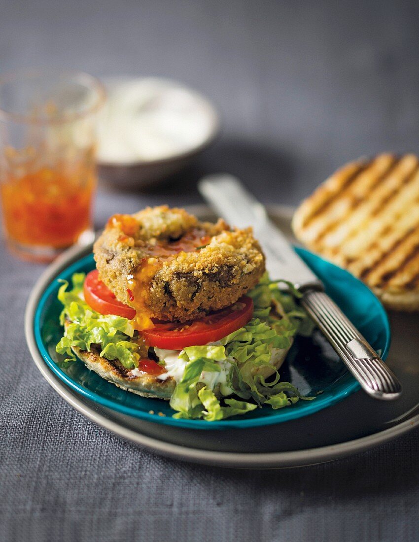 A burger with a breaded giant mushroom filled with cheese