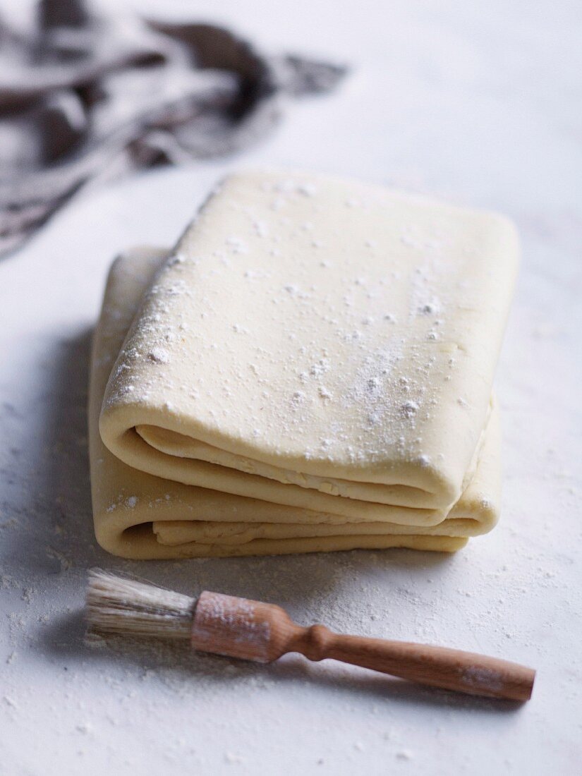 Fresh puff pastry, folded on floured work surface