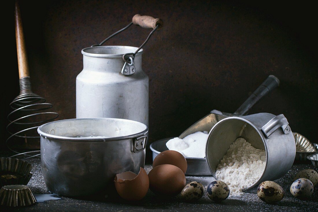 An arrangement of vintage utensils and ingredients for pancakes