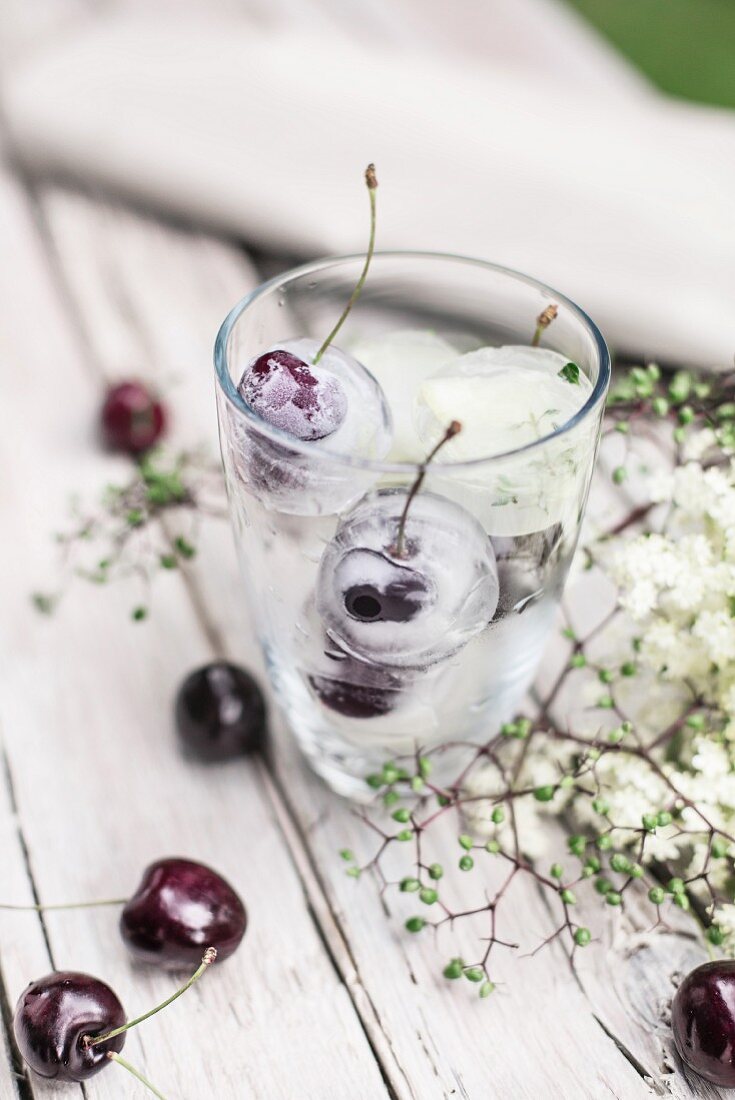 Ice cubes with cherries in a jar