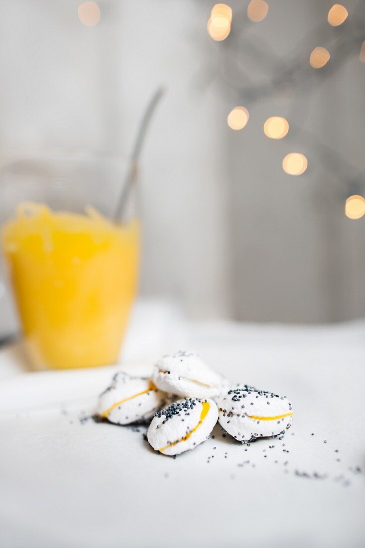 White macaroons with poppy seeds and lemon curd