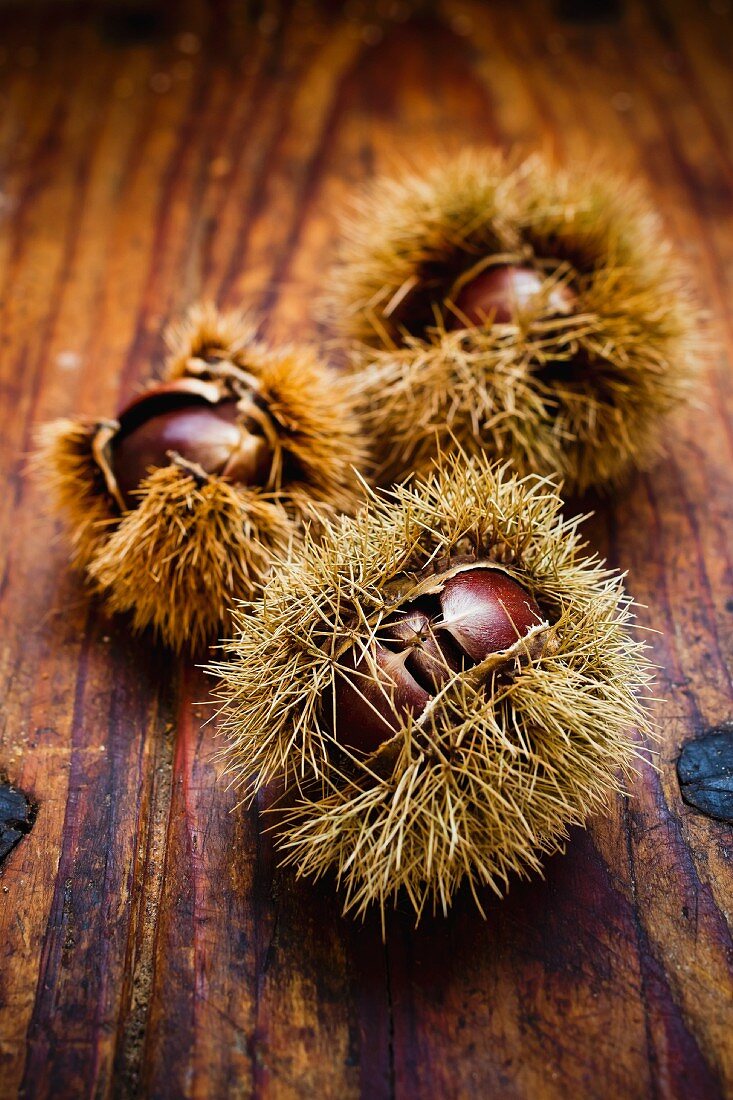 Edible chestnuts on a wooden surface