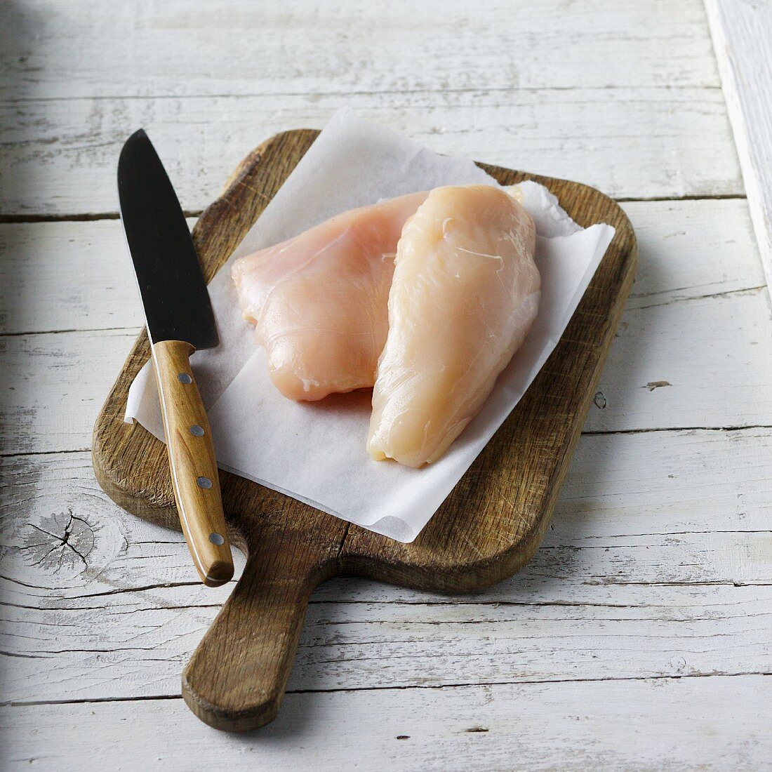 Lean chicken breast on a chopping board