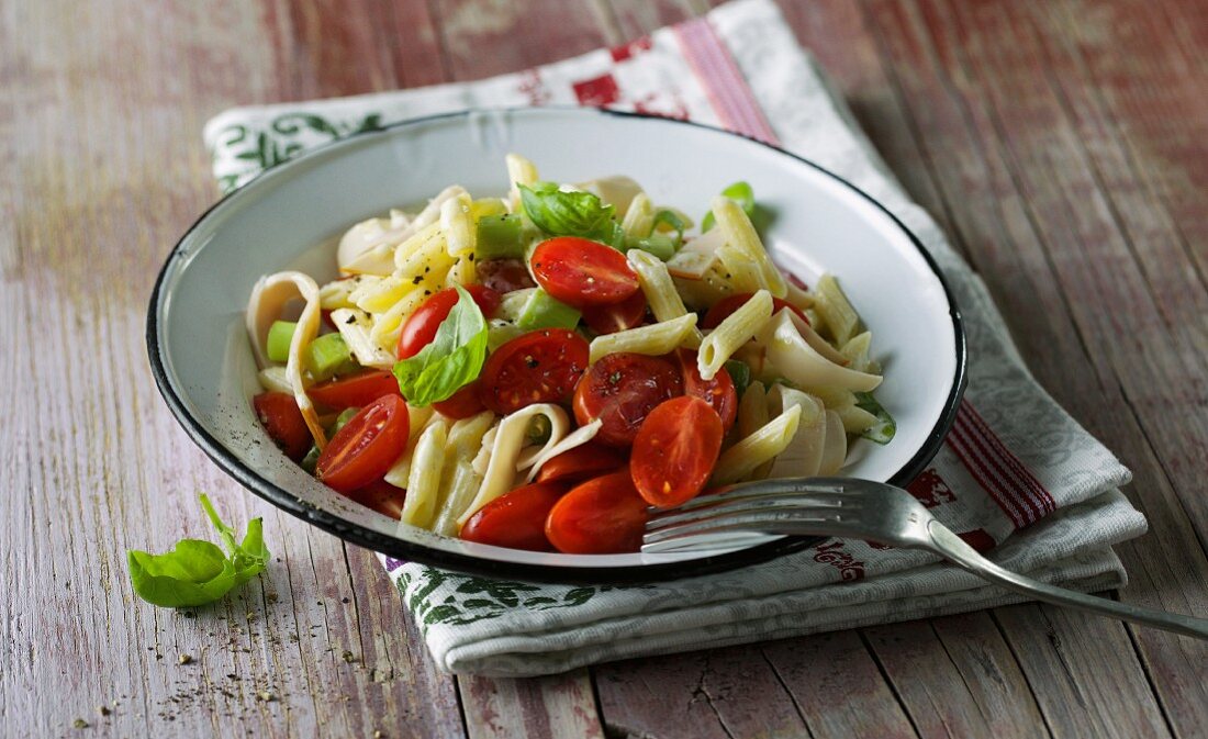 Penne pasta salad with cherry tomatoes, basil and chicken breast