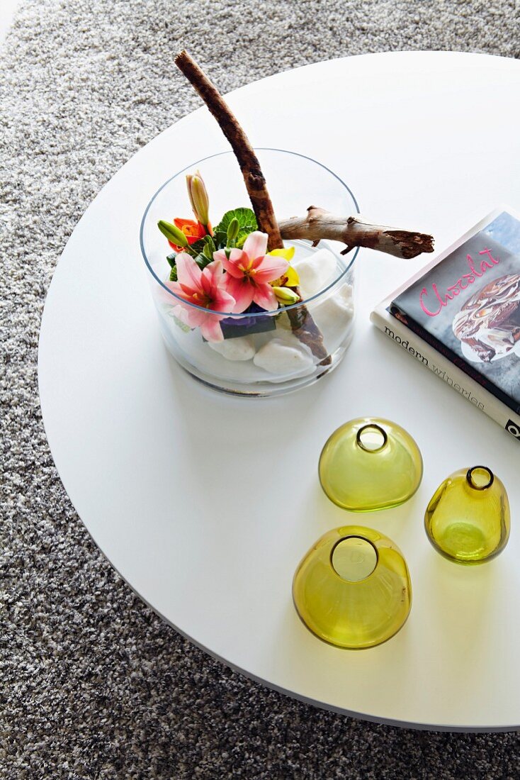 Ornaments on round white table on pale grey long-pile rug