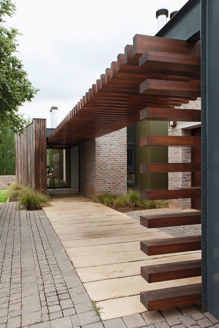 Walkway covered by modern steel and wood structure