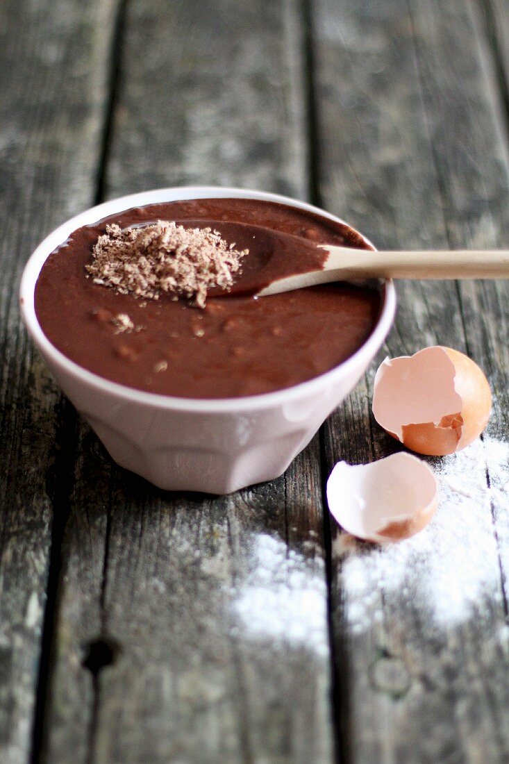 Bowl of Brownie Batter with Wooden Spoon; Egg Shells; Baked Brownies