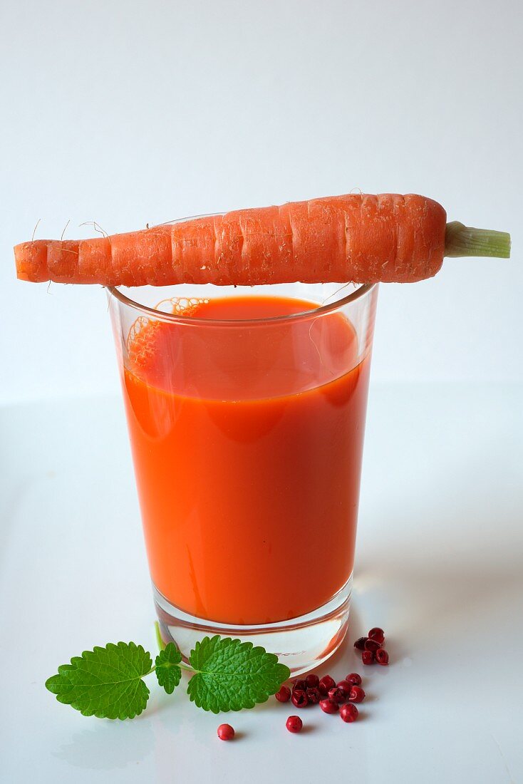 Fresh carrot juice with pink pepper and honey