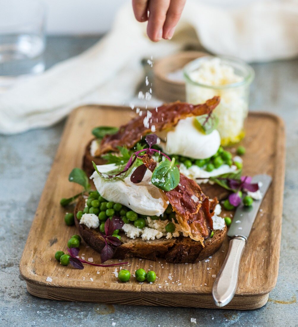 Belegtes Brot mit Käse bestreuen