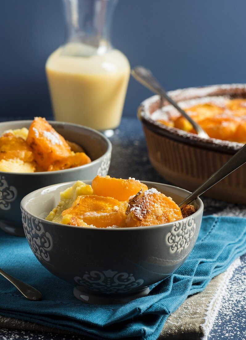 Calfoutis with apricots and icing sugar