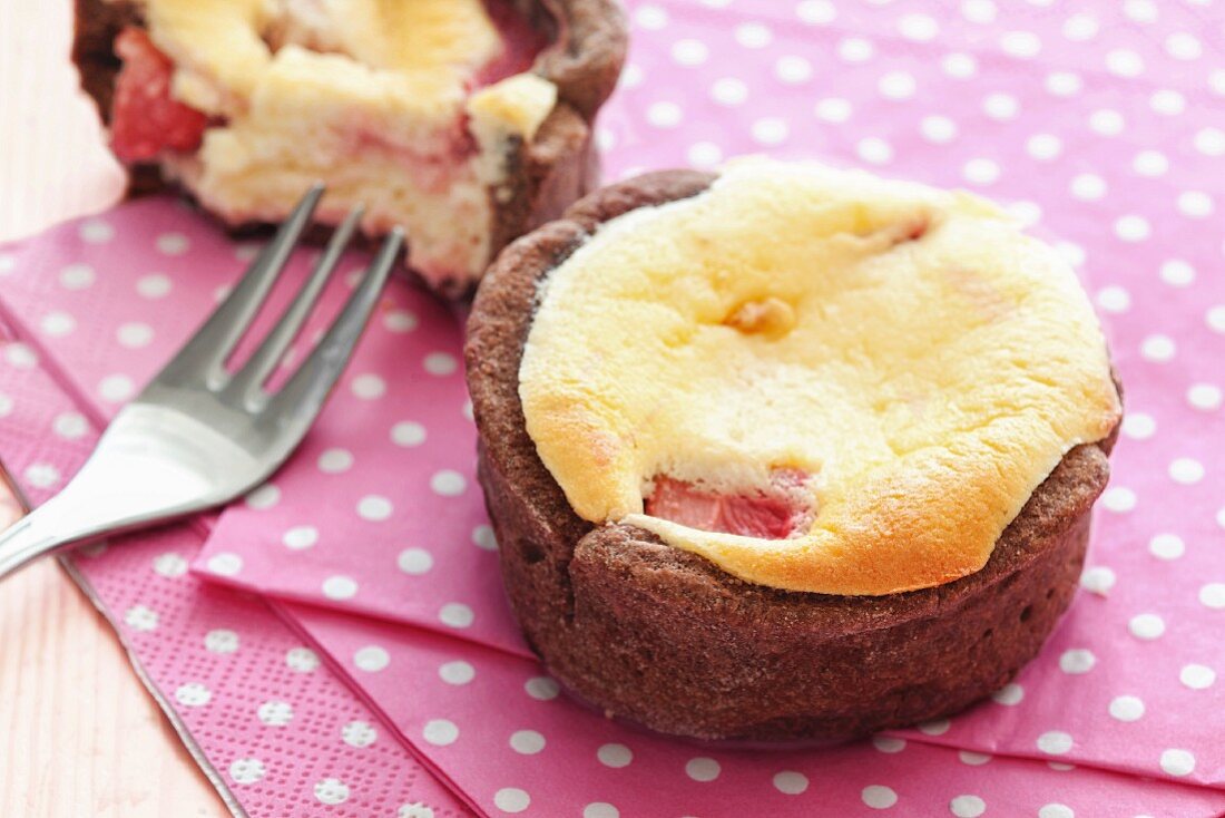 A mini strawberry cake with a chocolate edge baked in a muffin tin