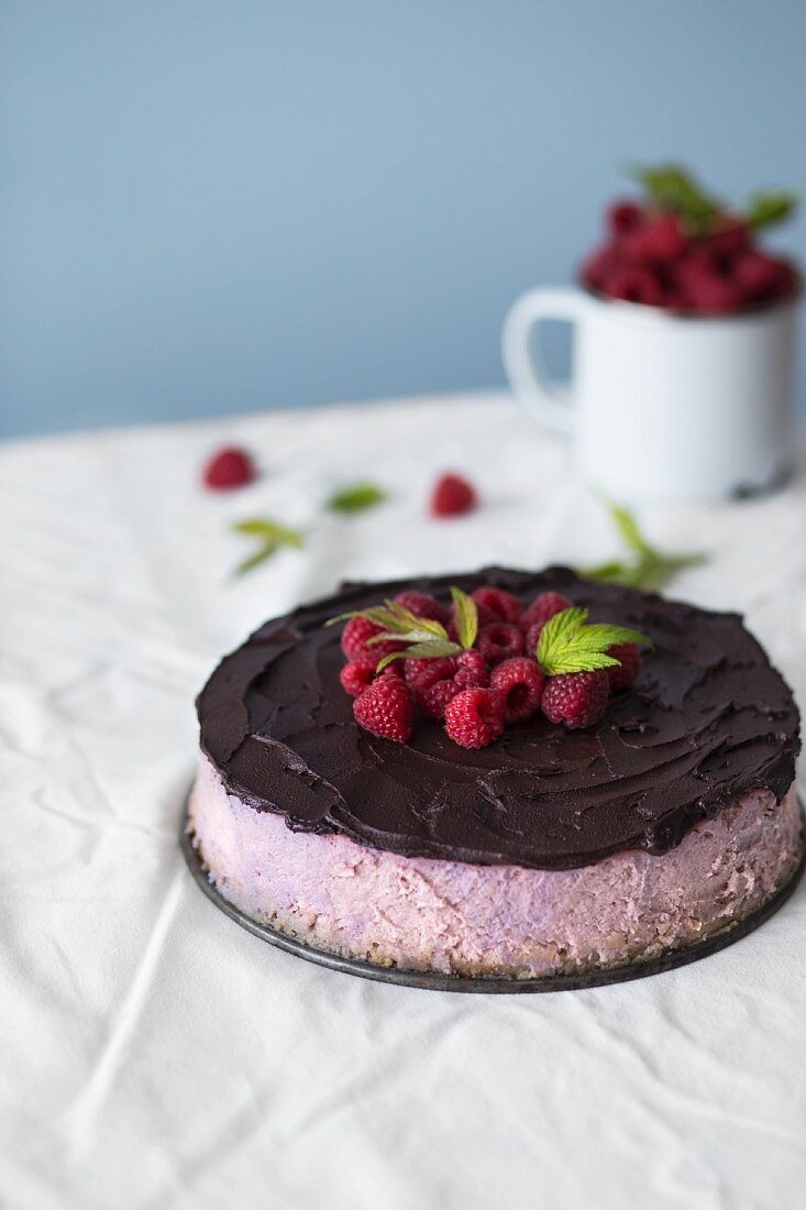 Raspberry cheesecake with chocolate glaze and fresh raspberries