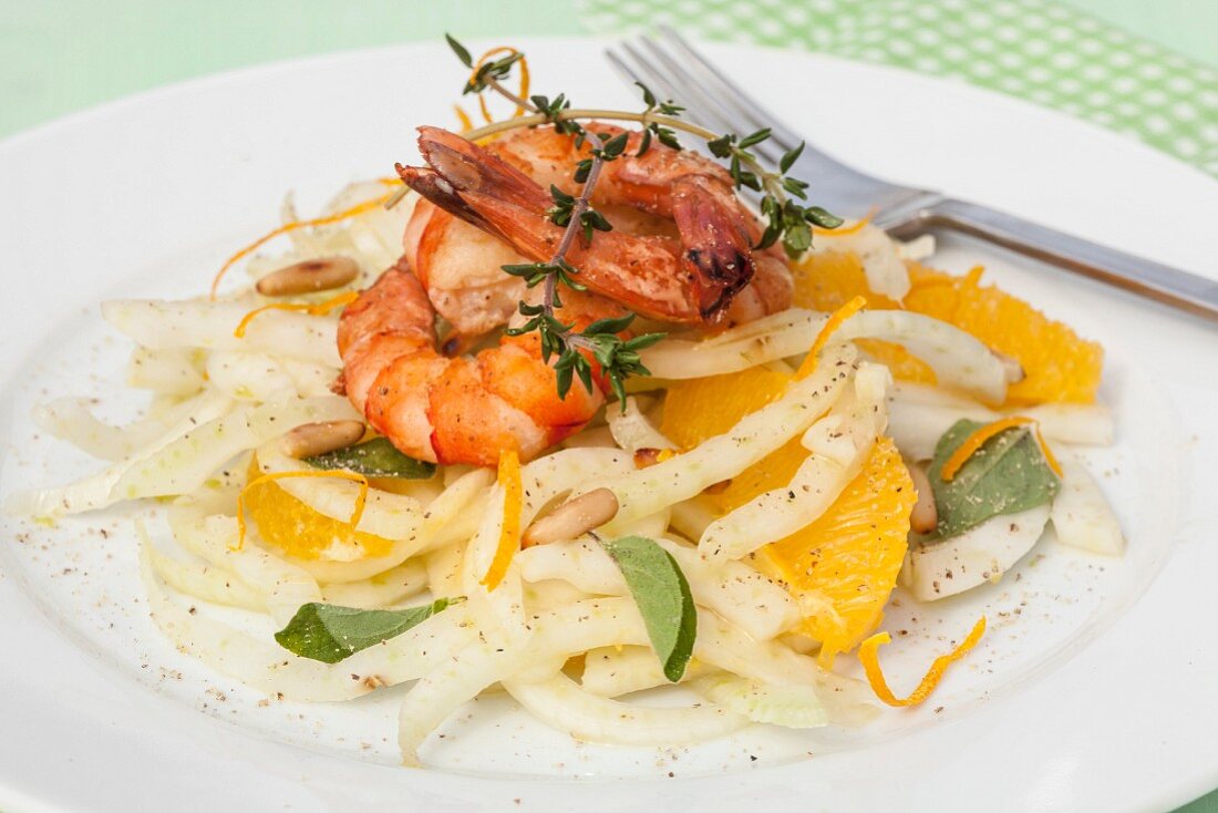 Fennel salad with grilled prawns, orange fillets, fresh herbs and pine nuts