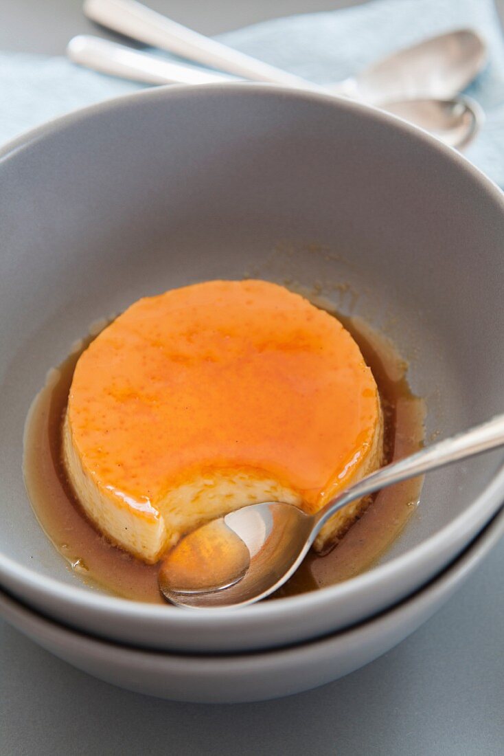 Caramel cream in a bowl with a spoon