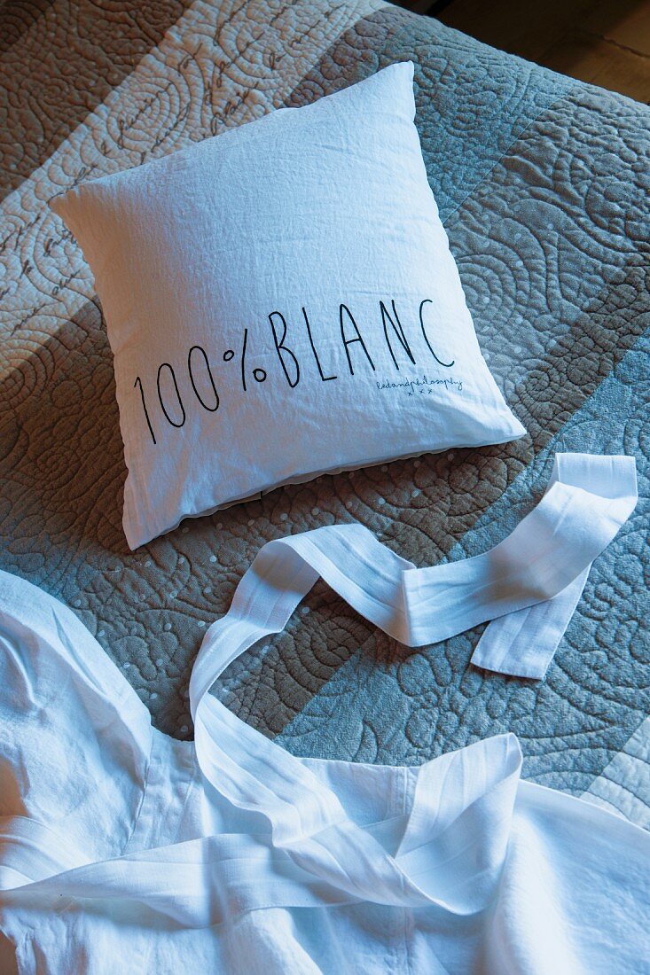 White cushion cover with lettering