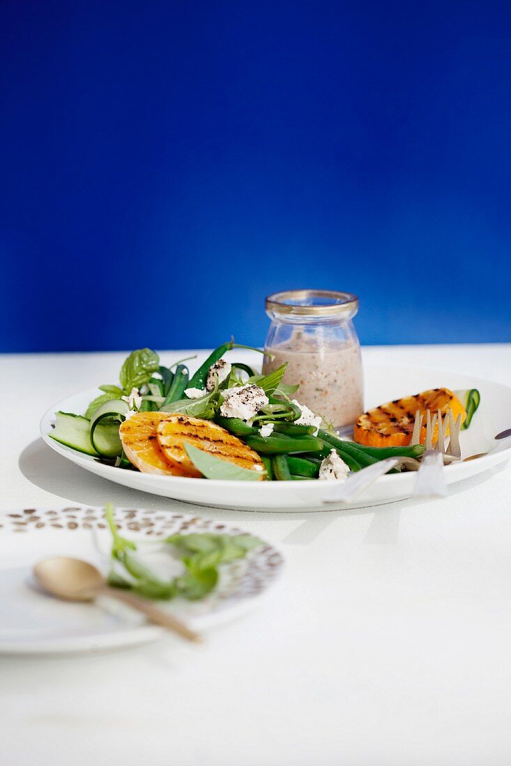 Grilled clementines served with bean salad with goat's cheese and walnut sauce