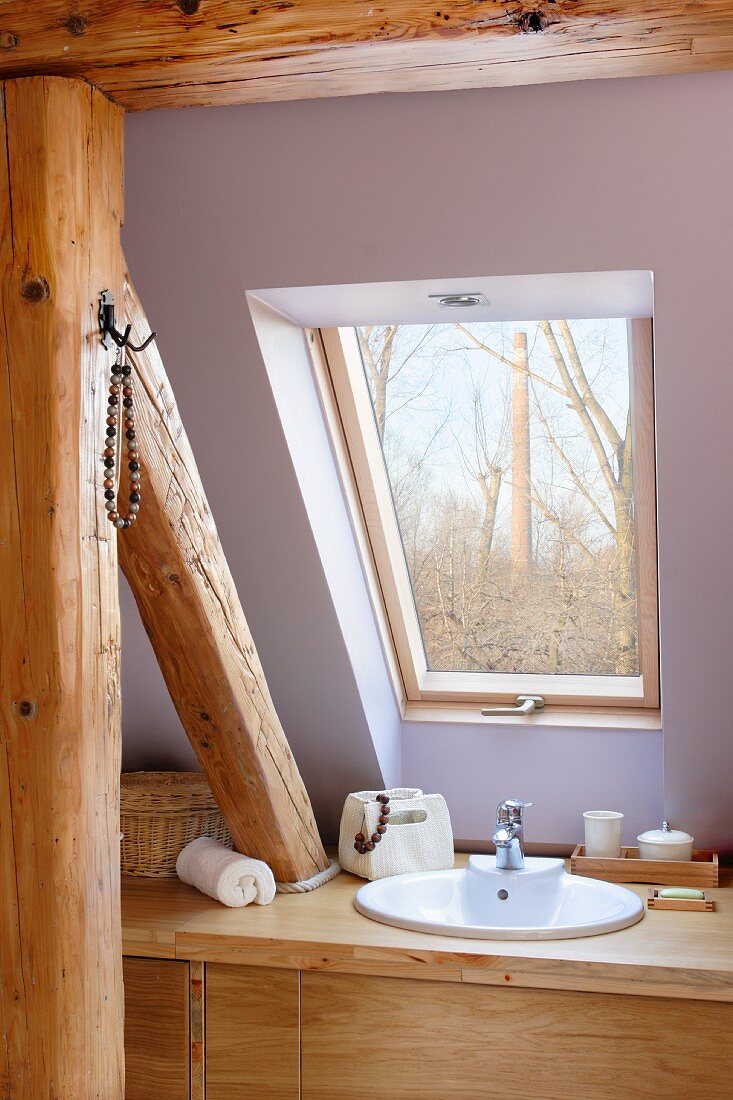 Washstand built around roof beam structure below skylight