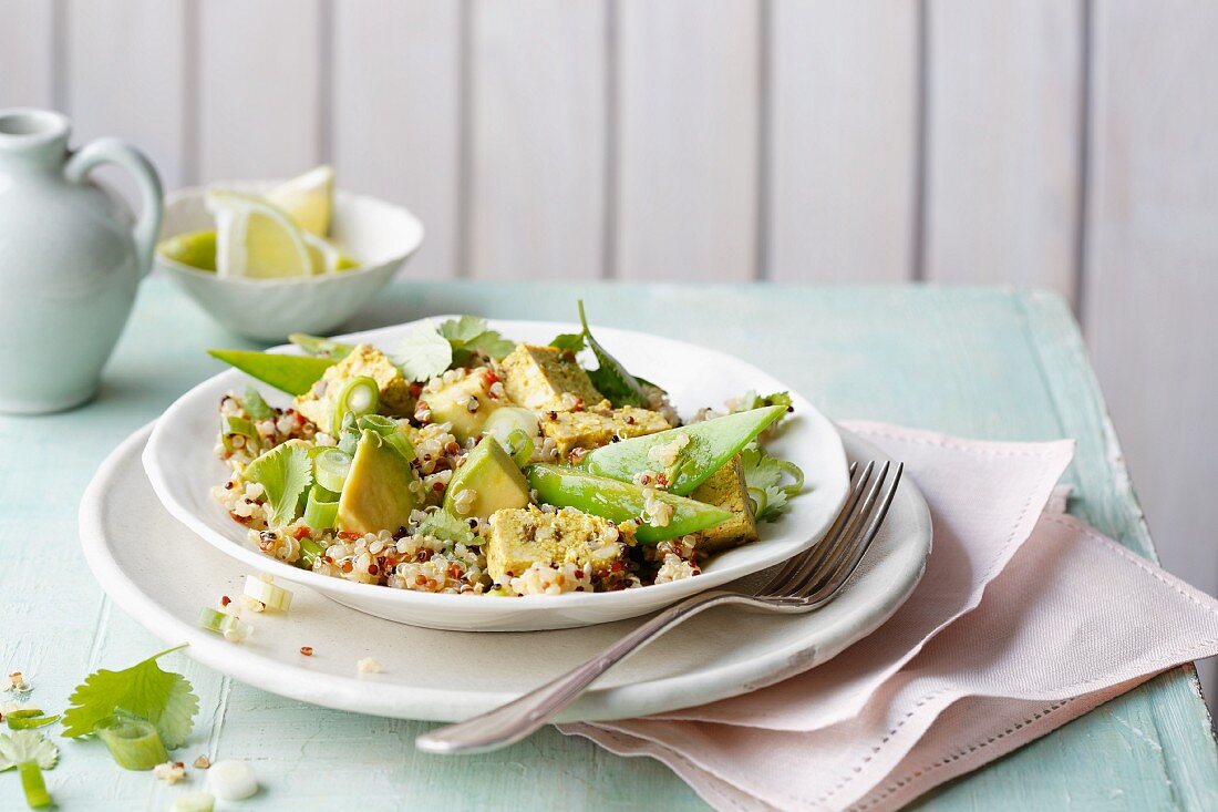 Quinoa and avocado salad with curry and mango tofu