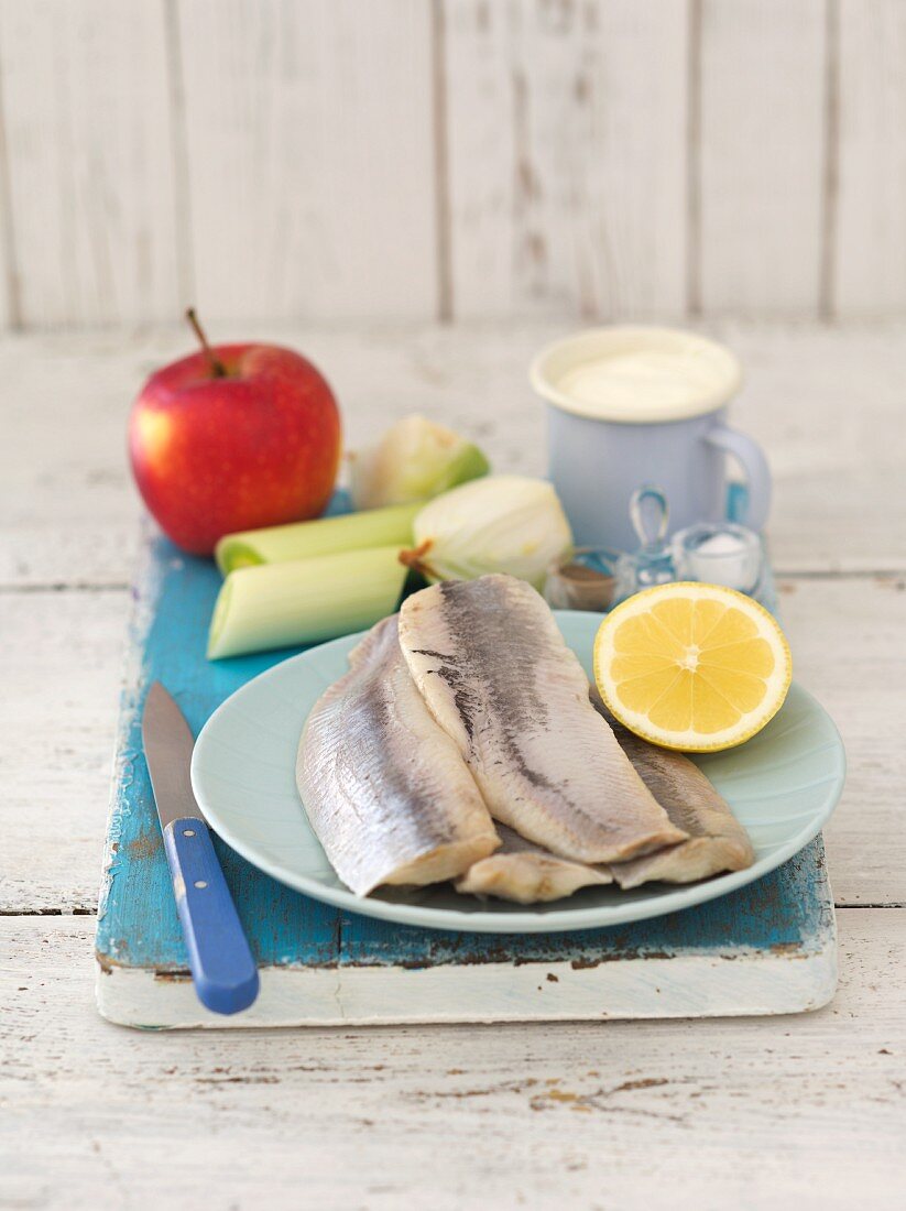 Ingredients for herring and apple salad: herrings, apple, onion, leek, sour cream