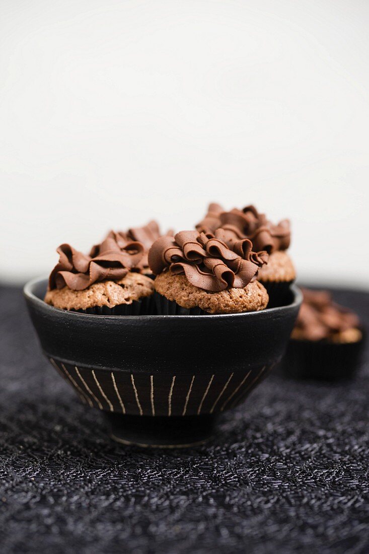 Minicupcakes (Schoko) mit Schokoladenganache-Topping in einer Schale