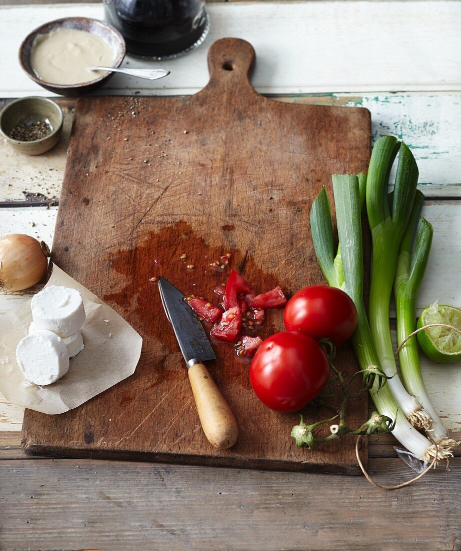 Various salad ingredients on a wooden chopping board