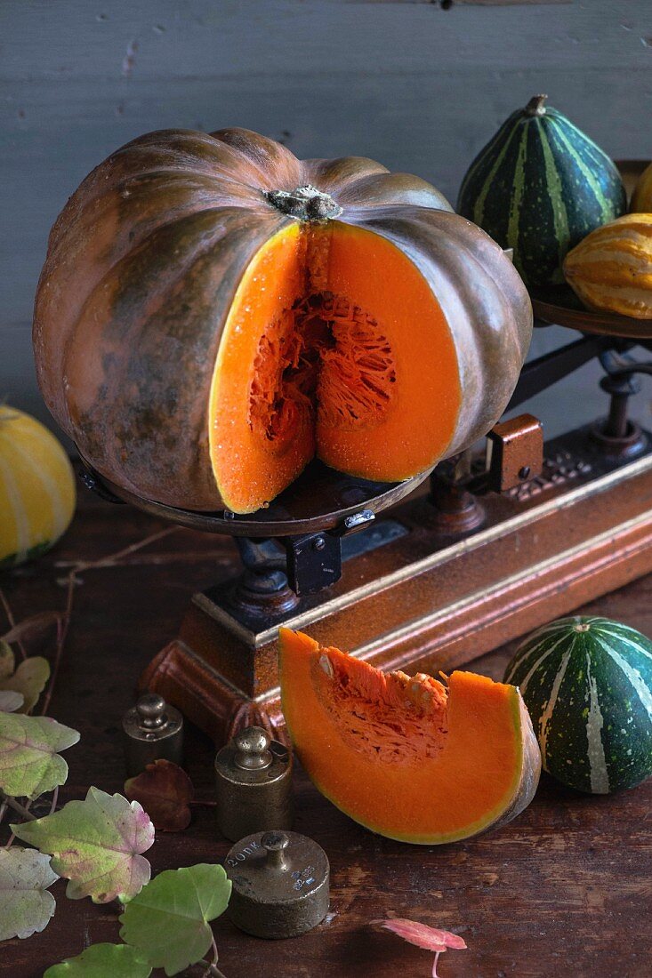 Pumpkins on a wooden table with an old pair of kitchen scales
