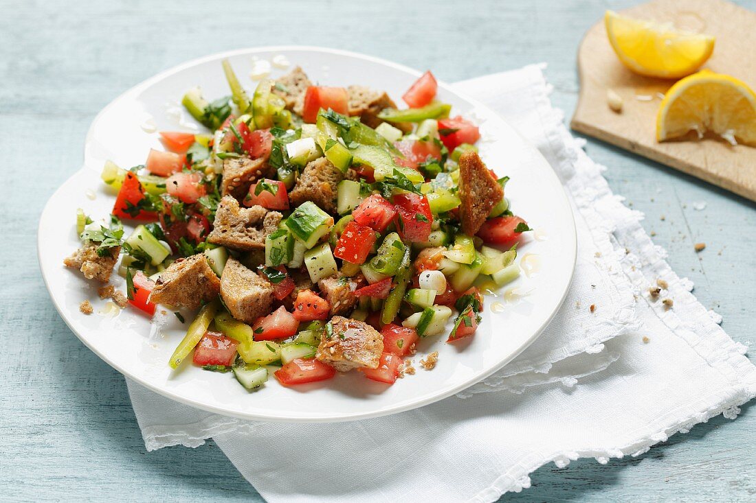 A summer bread salad with wholemeal baguette, tomatoes and cucumber