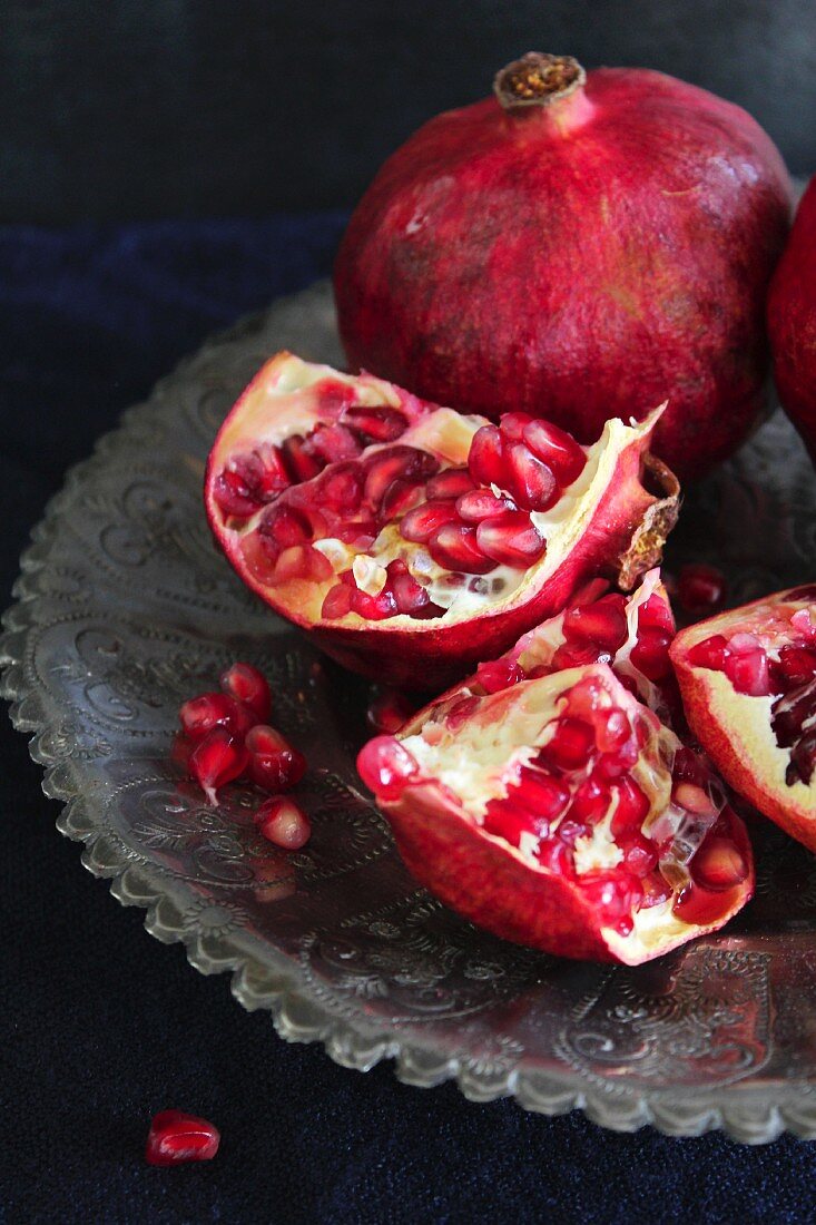 Pomegranates, whole and cut open