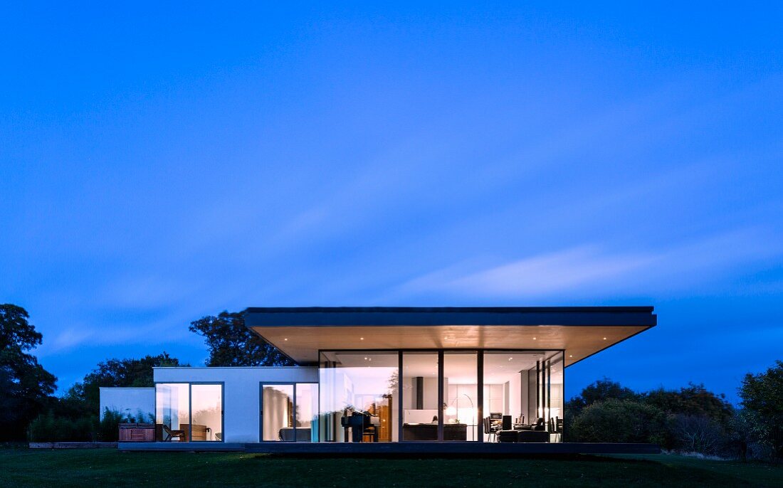 Modern house at night with illuminated interior