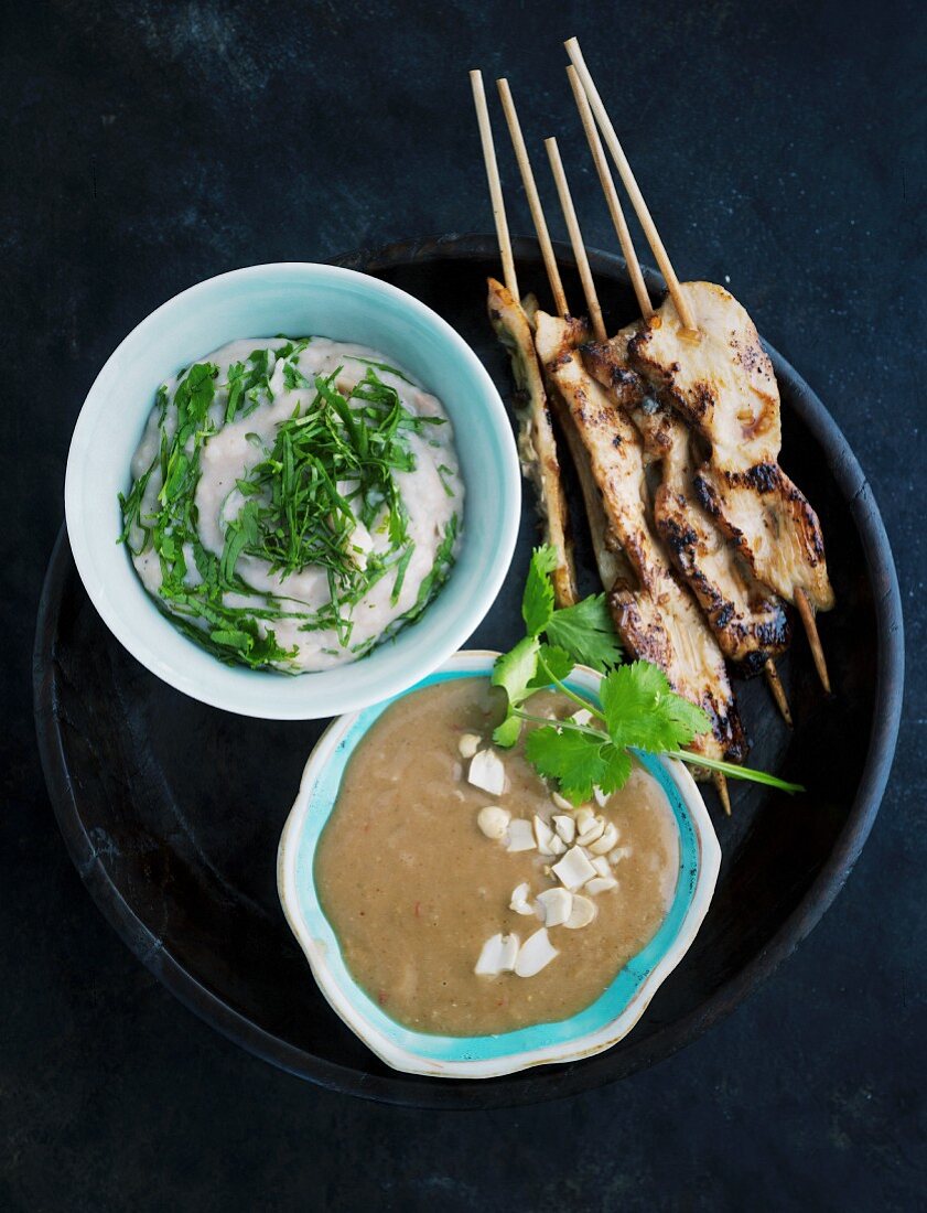 Chickens sate skewers with a bean mousse and peanut sauce