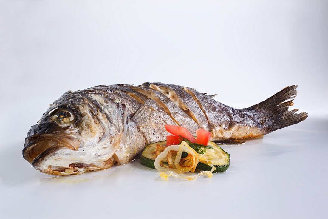 Fried catfish with a side of vegetables