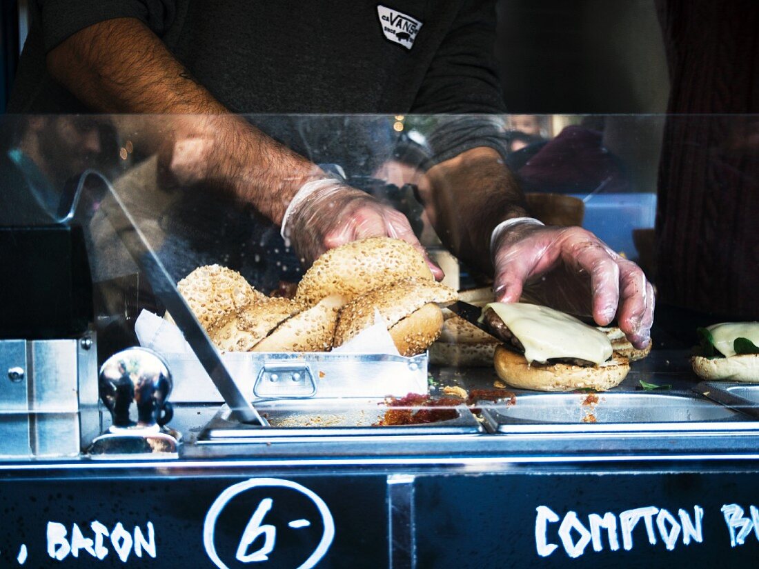 A cheeseburger being prepared in a food truck