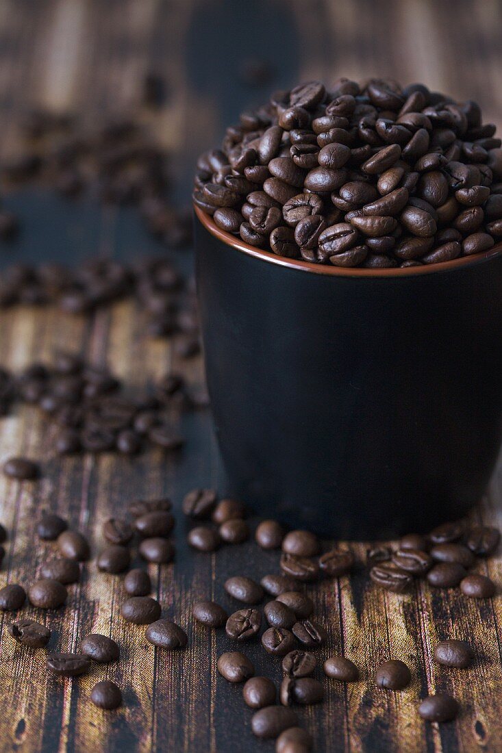 Coffee beans in a dark cup