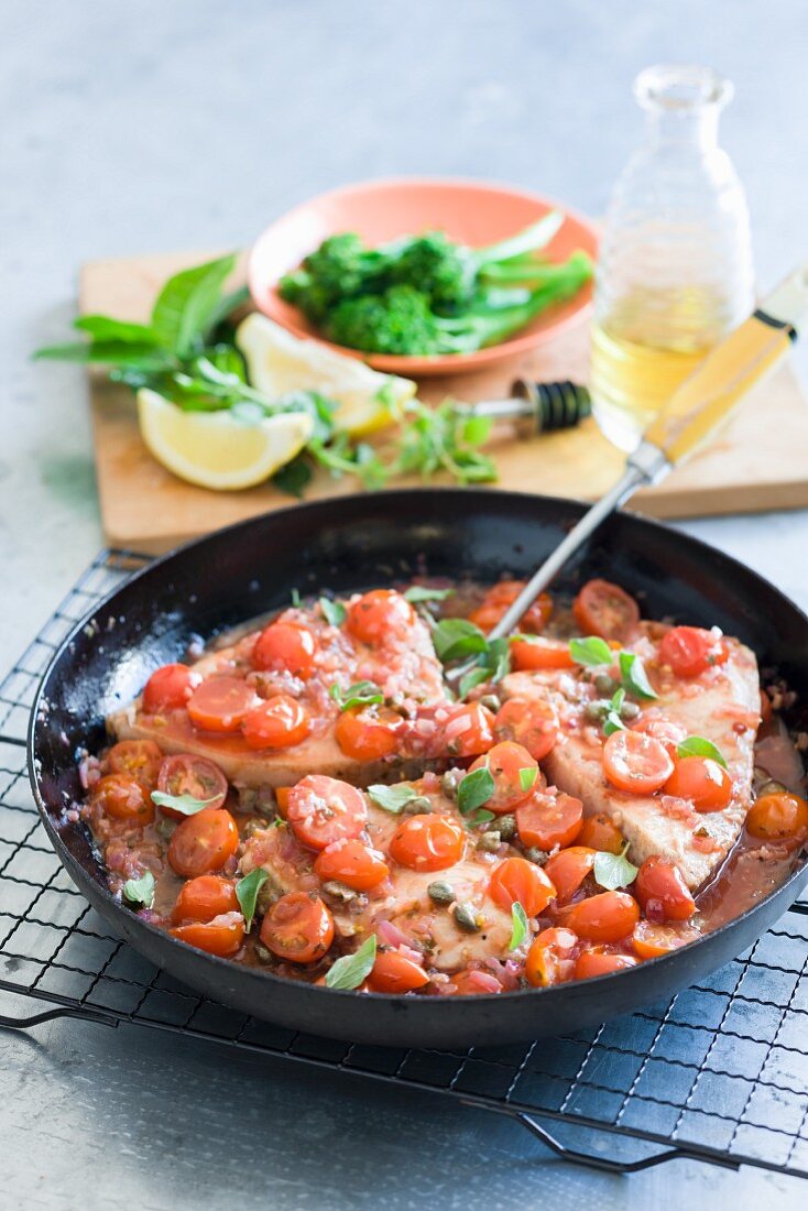 Swordfish steaks with cherry tomatoes and capers