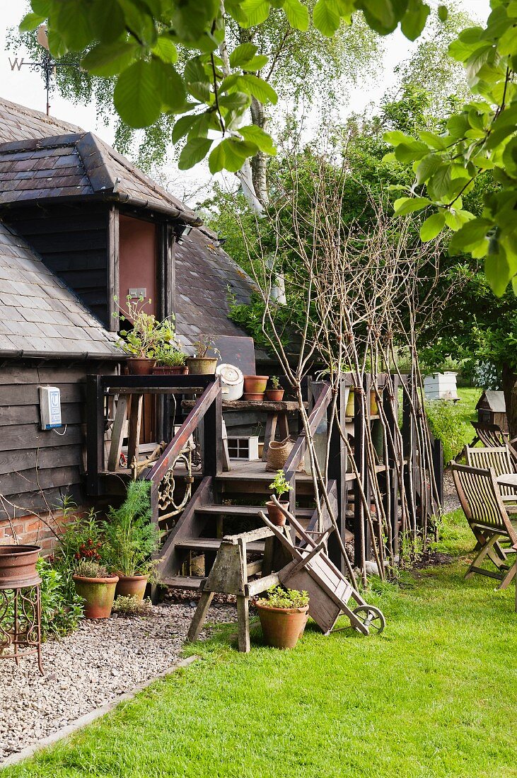 Old-fashioned wooden house with veranda and lawns