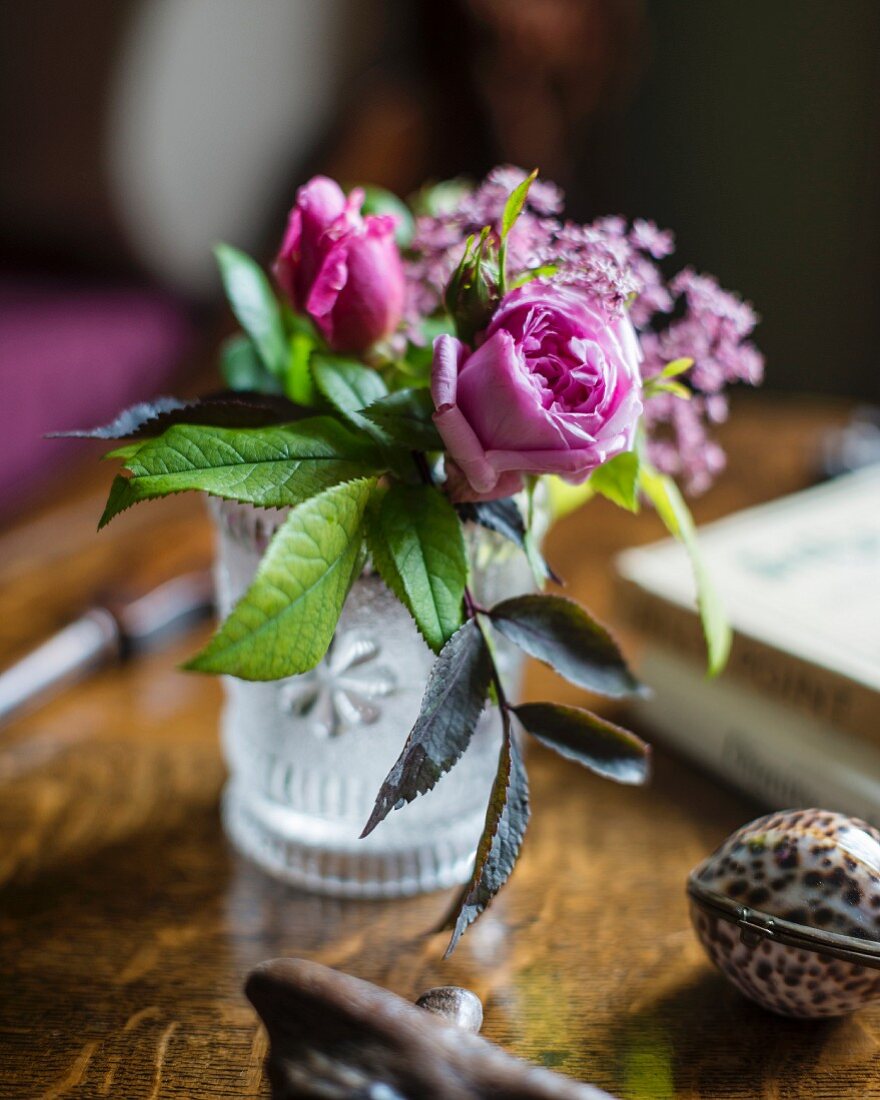 Posy of pink roses in glass vase